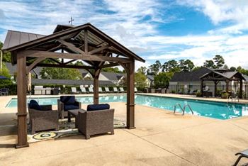 Resort-inspired pool with cabanas & outdoor kitchen